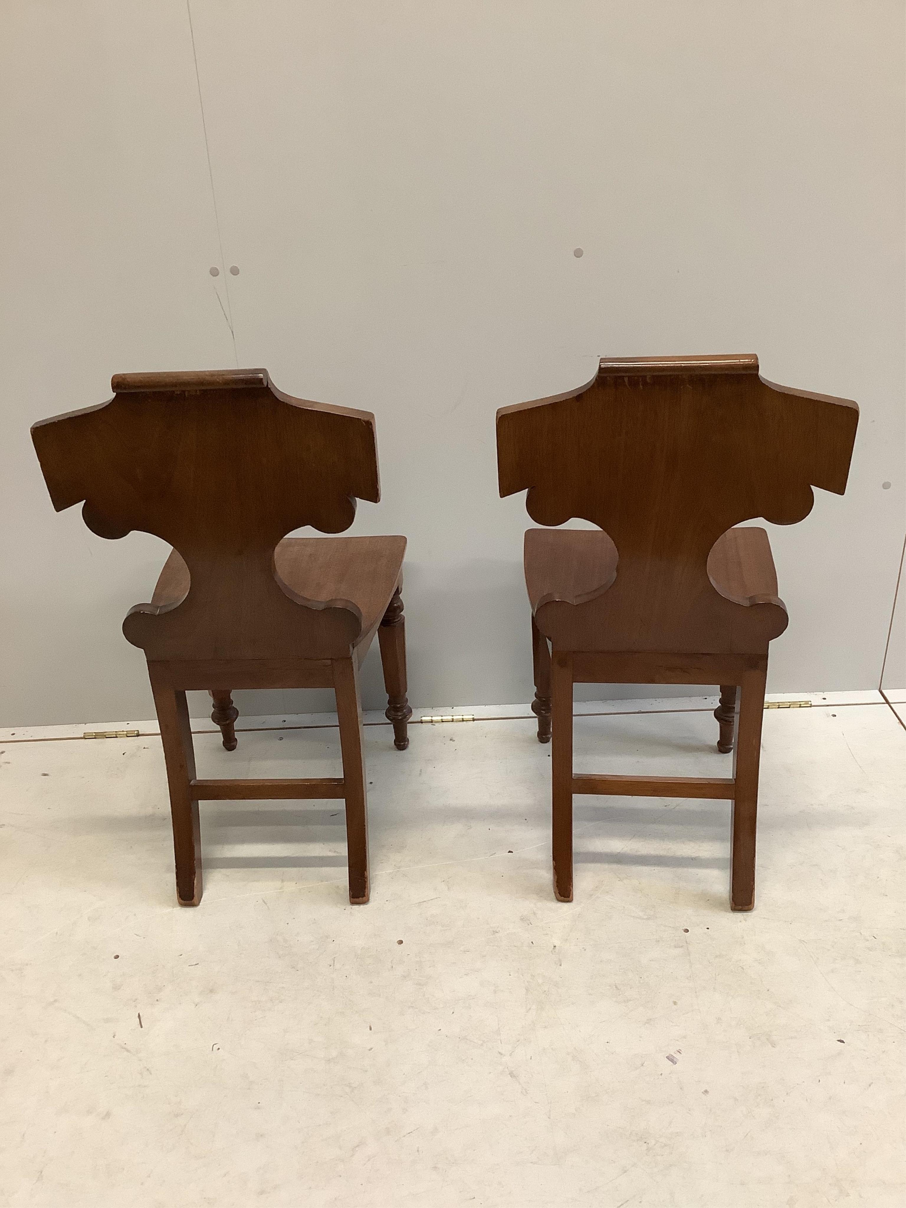 A pair of Victorian mahogany hall chairs, width 44cm, depth 40cm, height 88cm. Condition - fair